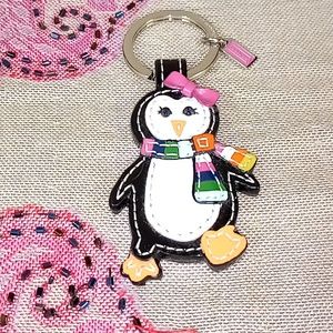 Coach Legacy scarf penguin keychain